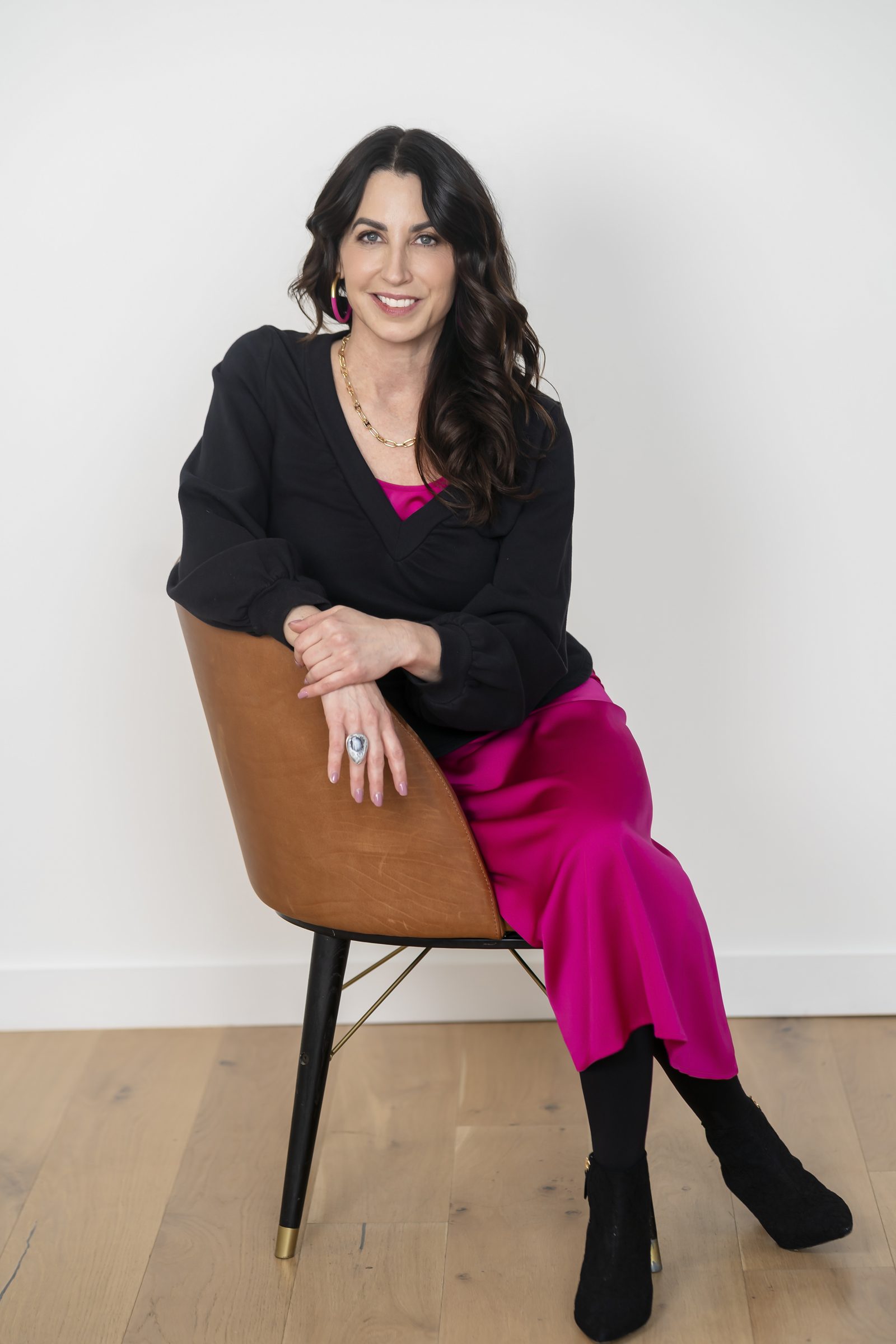 Susan Page in a cognac leather chair